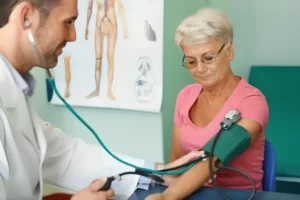 Elderly woman receiving blood pressure test.