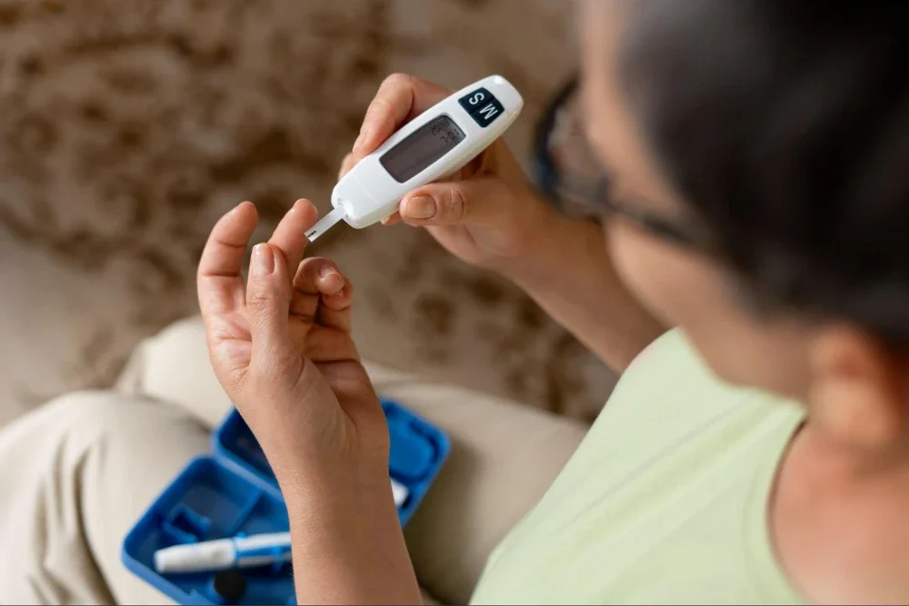 Woman checking blood sugar with glucometer.