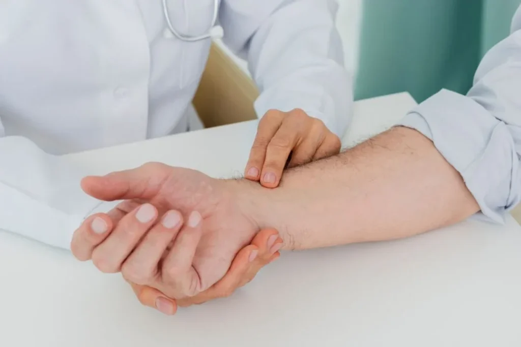 Doctor examining patient's hand for arthritis.