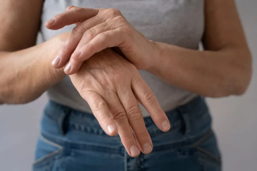 Person holding hand, indicating arthritis pain.